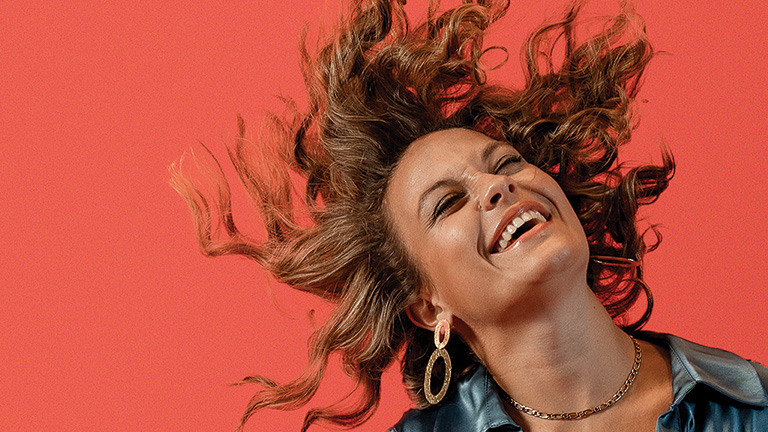 Happy model shaking her hair